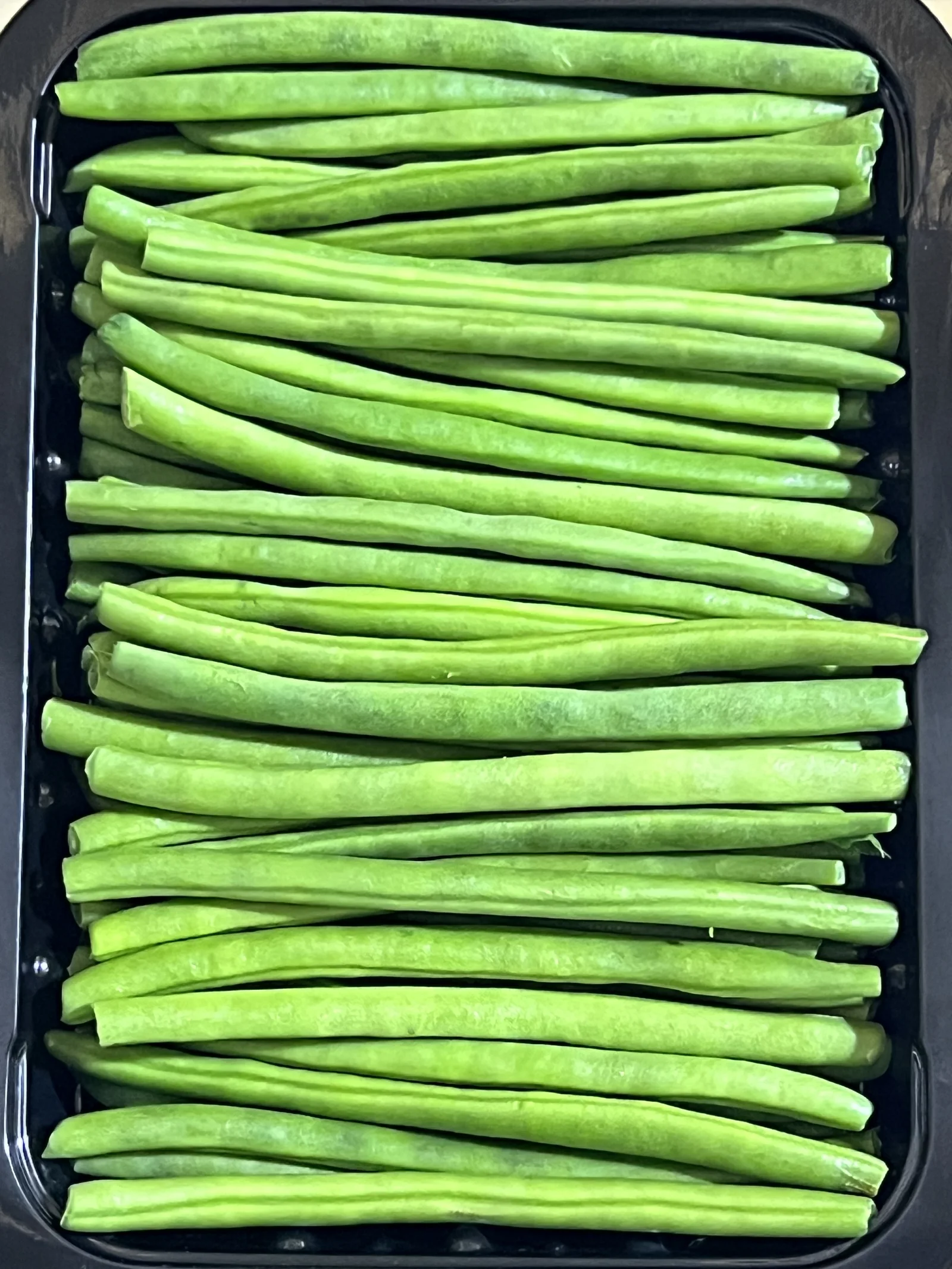 Extra fine French beans packed in a black tray