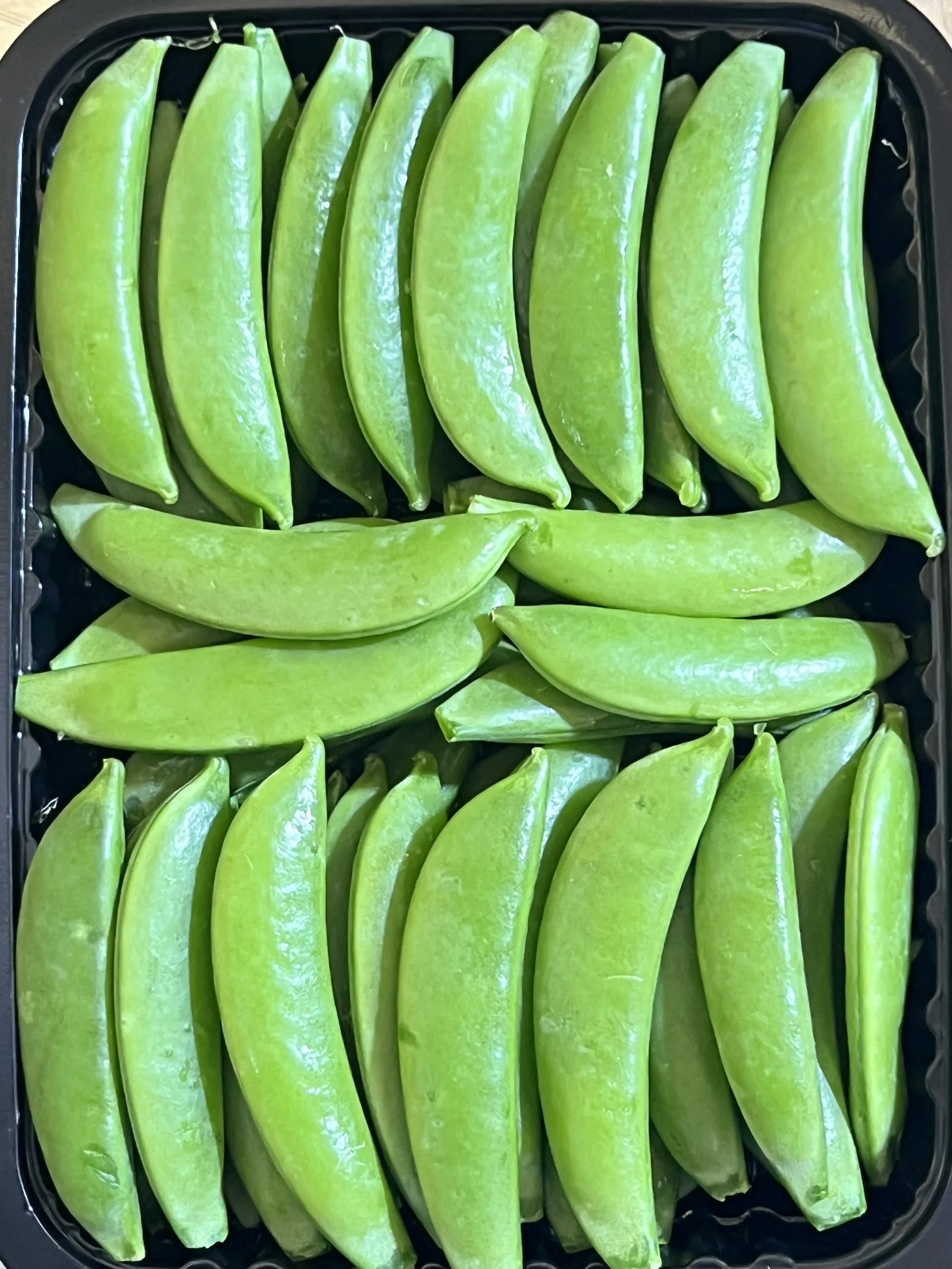 Sugar snap peas packed in a tray